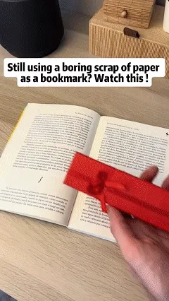 Decorative metal bookmark ruler in use